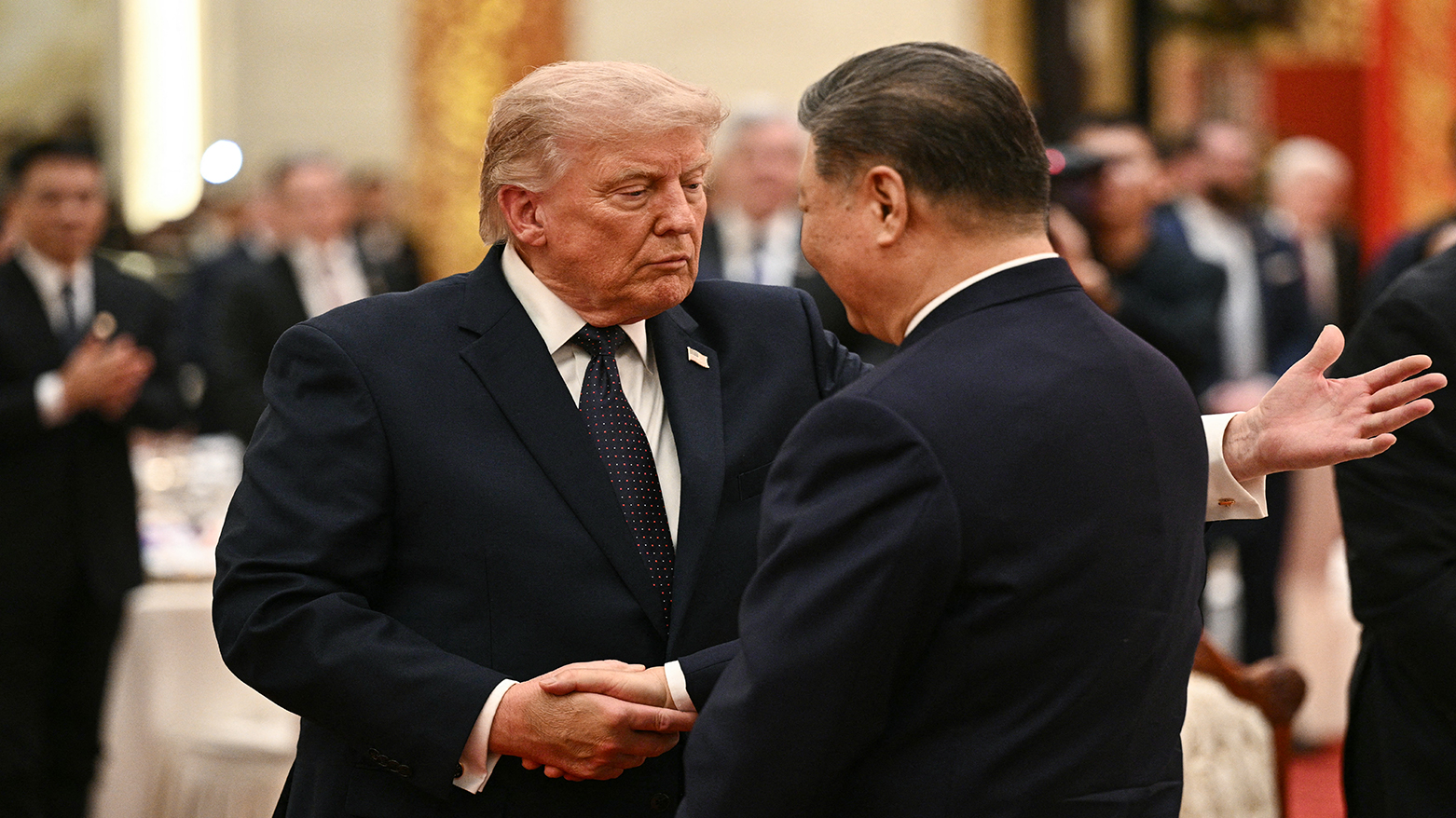 China's President Xi Jinping (R) and US President Donald Trump shake hands as they attend a state banquet at the Great Hall of the People in Beijing, May 14, 2026.