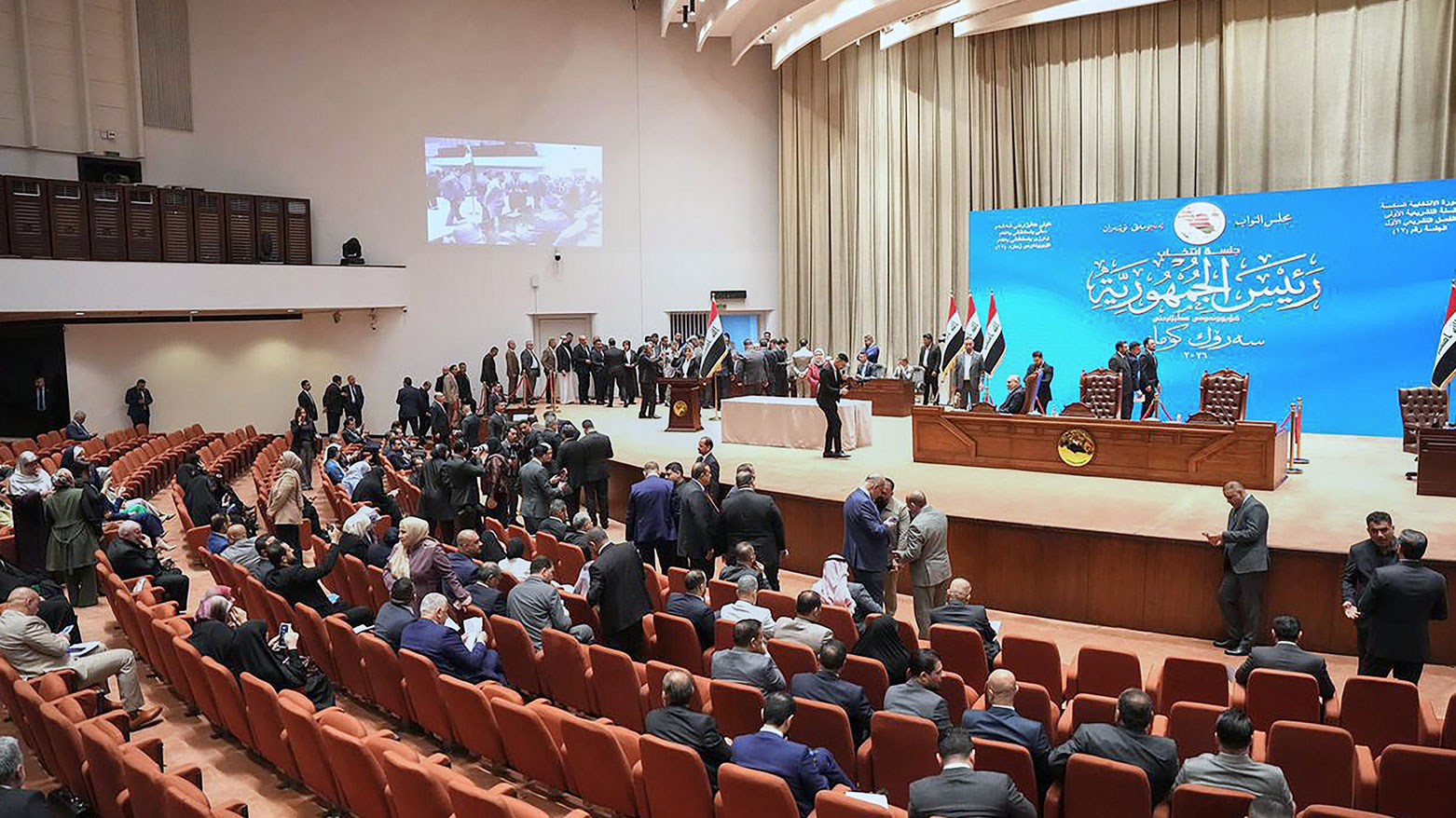 The photo shows members of the Iraqi Parliament during a voting session, Baghdad, Iraq. (Iraqi Parliament Media Office via AP)
