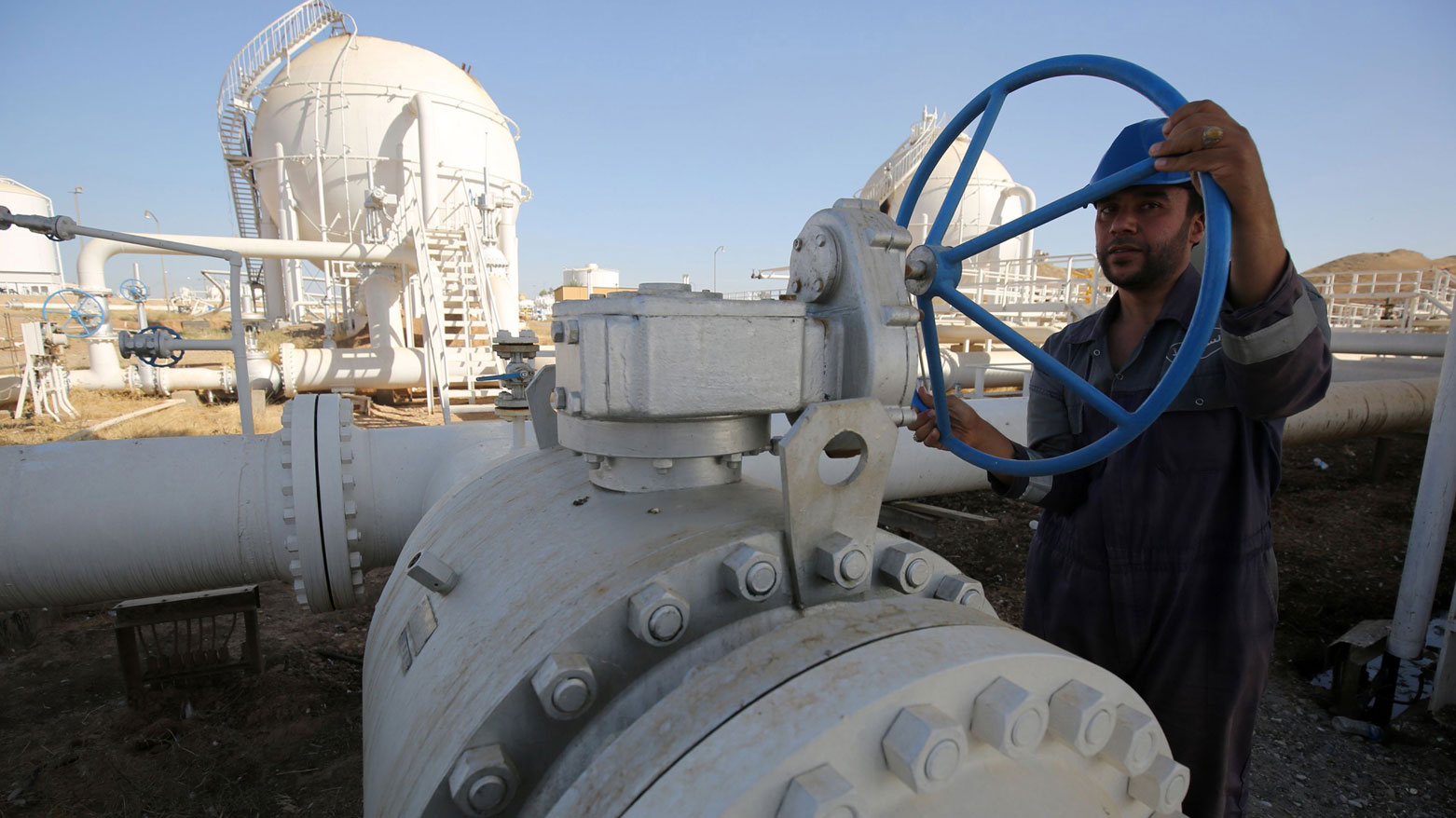 A worker checks pipelines at the Bai Hassan oil field, west of Kirkuk. (AFP)