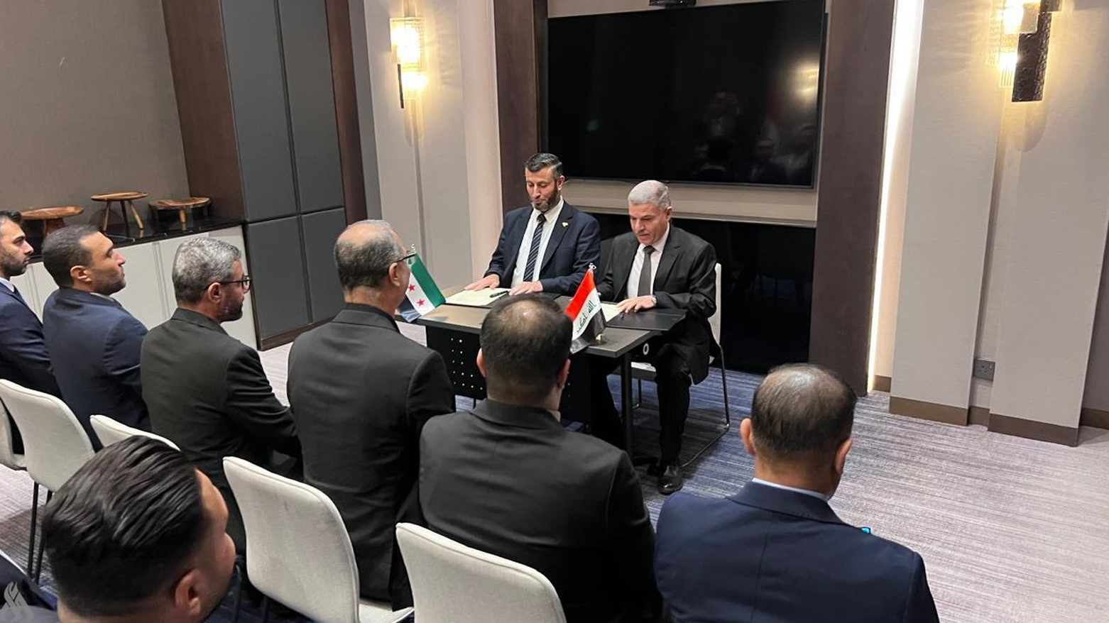 The moment of signing the agreement between Iraq and Syria. (Photo: INA)