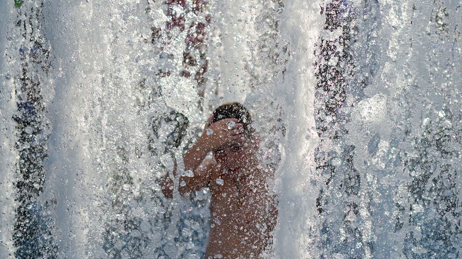 A child cools off in a public fountain in Belgrade, on Jun. 27, 2026 as Serbia endures a heatwave. (AFP)