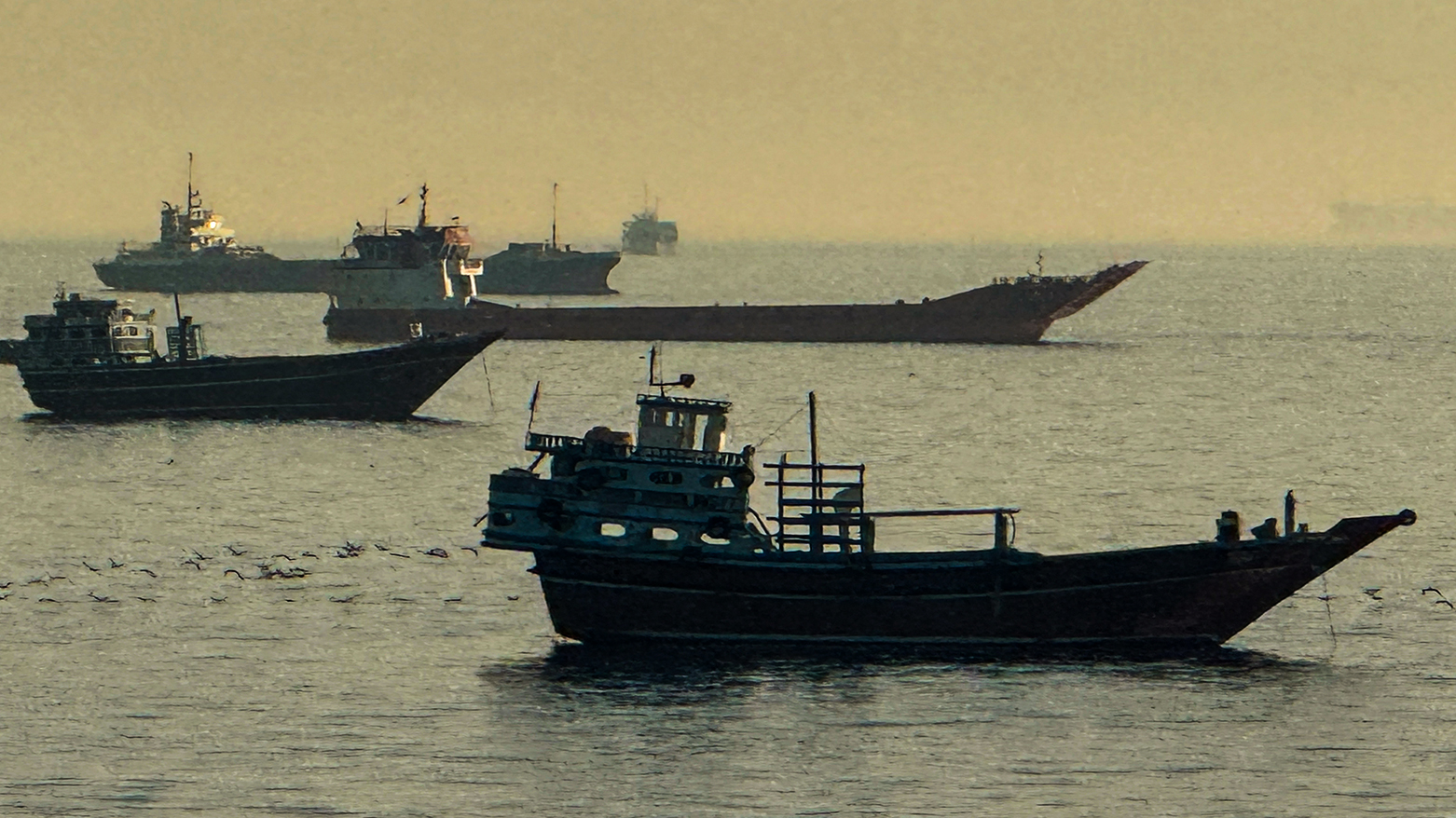 Vessels are seen anchored in the Strait of Hormuz, off the port city of Khasab on Oman’s northern Musandam Peninsula on May 17, 2026. (AFP)