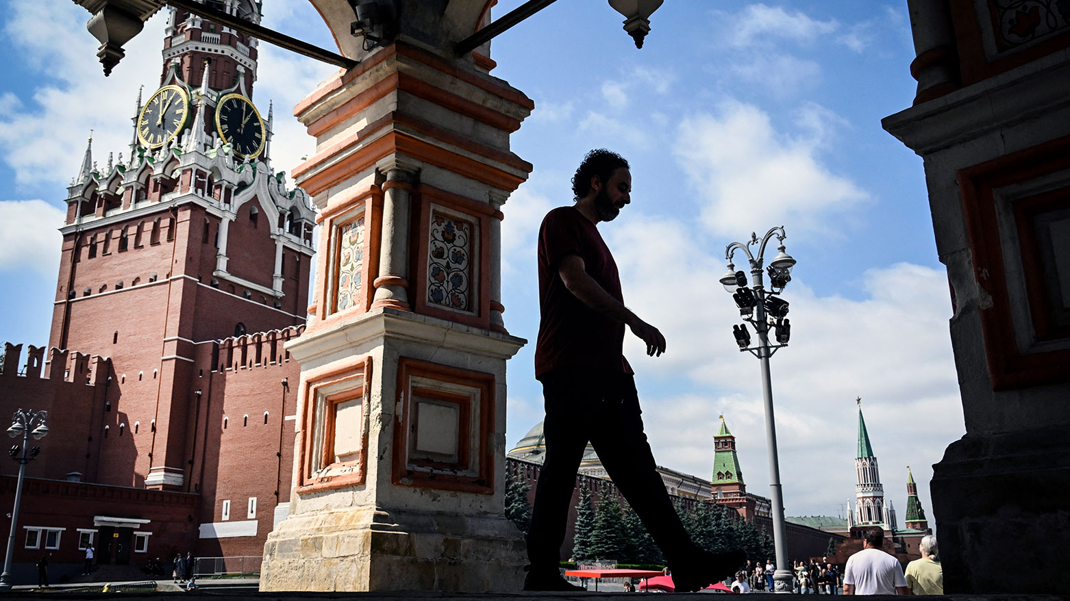 A man walks out of St. Basil's cathedral in front of the Spasskaya tower at Red Square in central Moscow on July 15, 2026. (AFP)