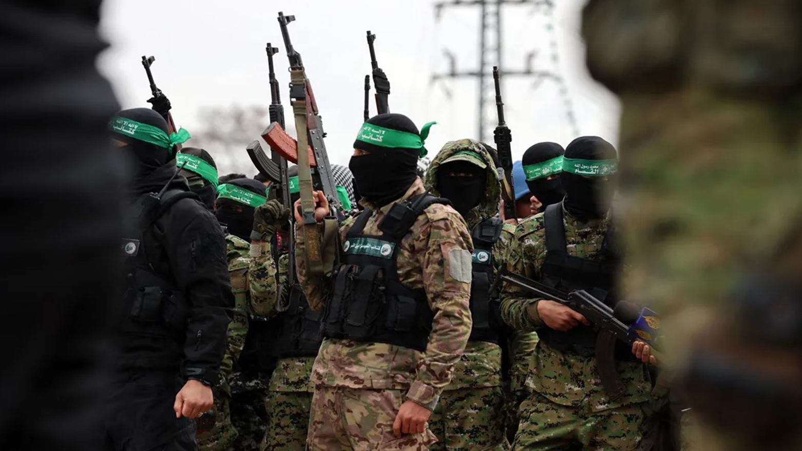 Hamas fighters gather at the site of the handing over of two Israeli hostages in Rafah, southern Gaza Strip, as part of the seventh hostage-prisoner release on Feb. 22, 2025. (AFP)