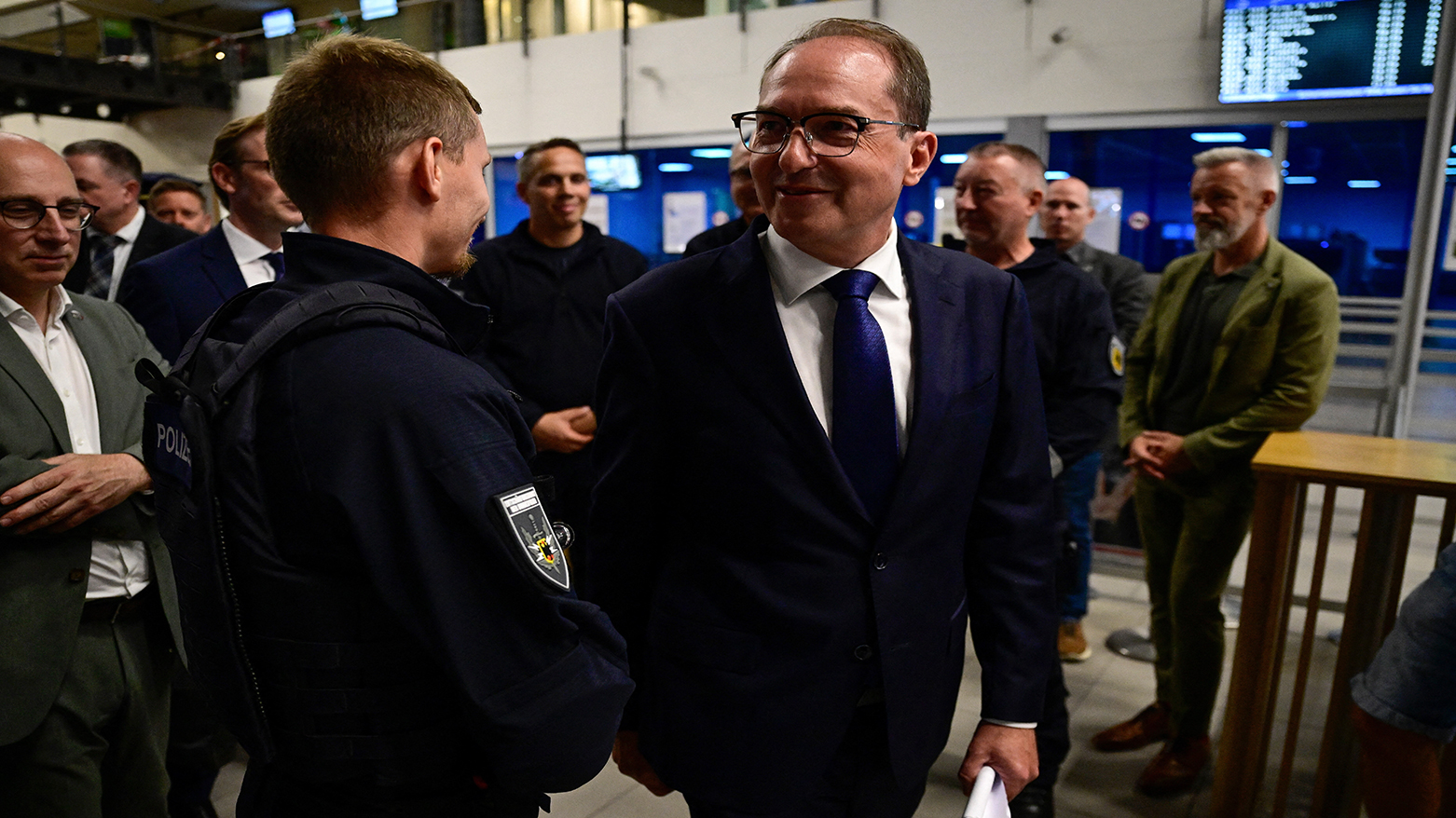 German Interior Minister Alexander Dobrindt thanks police officers at Leipzig-Halle Airport on Aug. 5, 2026, after an explosives-laden drone was found near a Ukrainian cargo plane. (AFP)