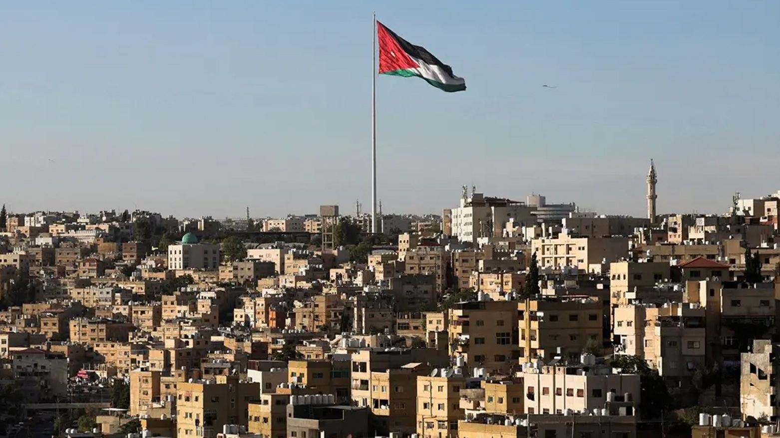 A Jordanian flag flies over the capital city, Amman, Jordan August 17, 2025. (Reuters)