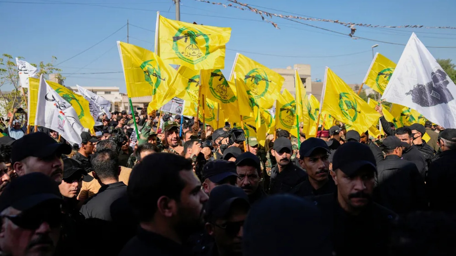Members from the PMF attend the funeral of fighters from Kataib Hezbollah (AP)