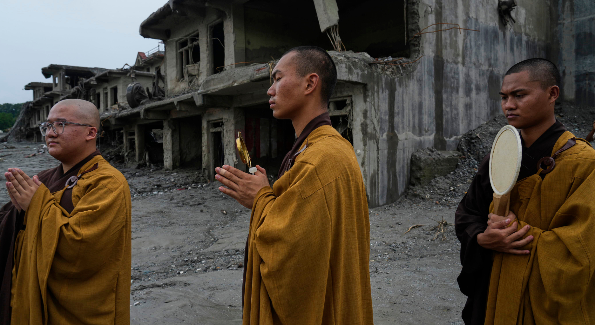 Buddhist monks offer prayers for the departed soul of the victims of flash flood on the bank of Trishuli river in Devighat, Nuwakot district, Nepal, Saturday, Sept. 5, 2026. (AP)
