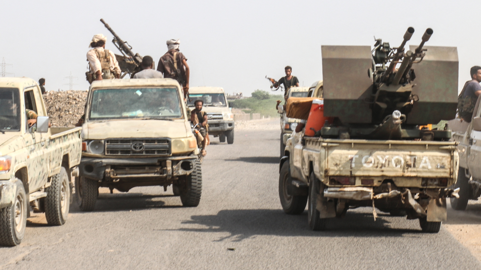 Forces loyal to Yemen's Saudi-backed government ride in pick-up trucks along a road in the Hays district, south of Hodeidah, Sept. 5, 2026. (AFP)