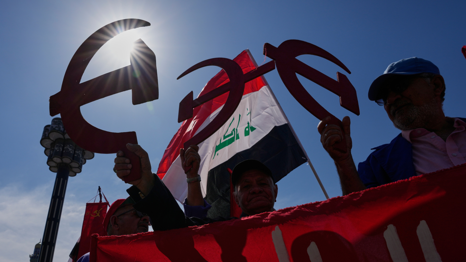 Supporters of the Iraqi Communist Party holds a symbolic hammer and sickle  in Baghdad, Iraq, Friday, May 1, 2026. (AP)