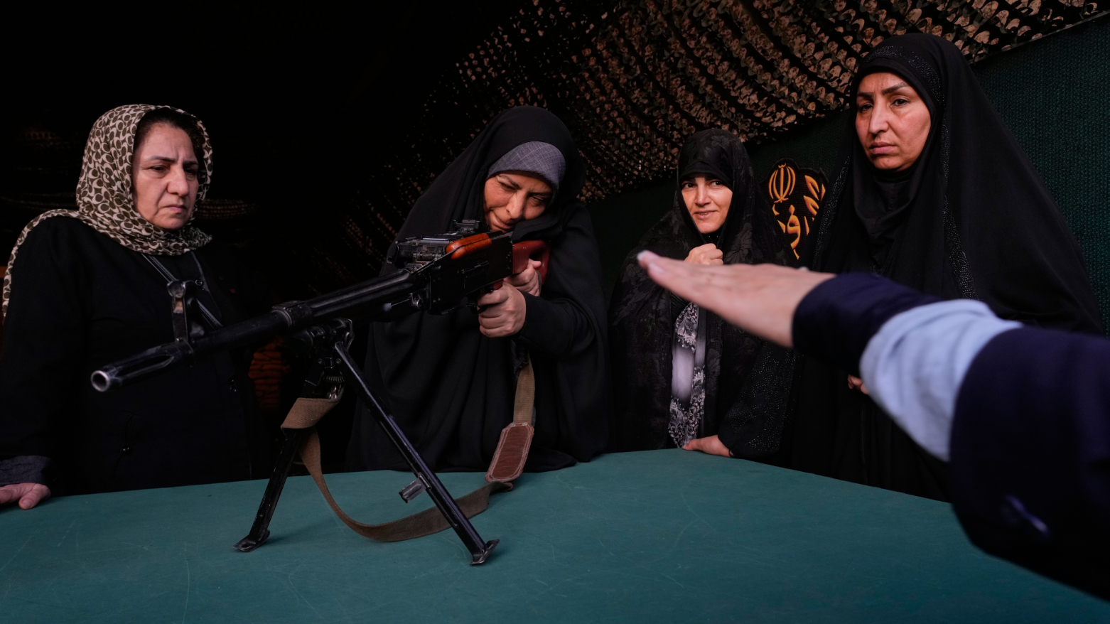 A volunteer trains how to handle a weapon while attending a military training course at a camp set up in Imam Hussein Square in Tehran, Sunday, Oct. 4, 2026. (AP)