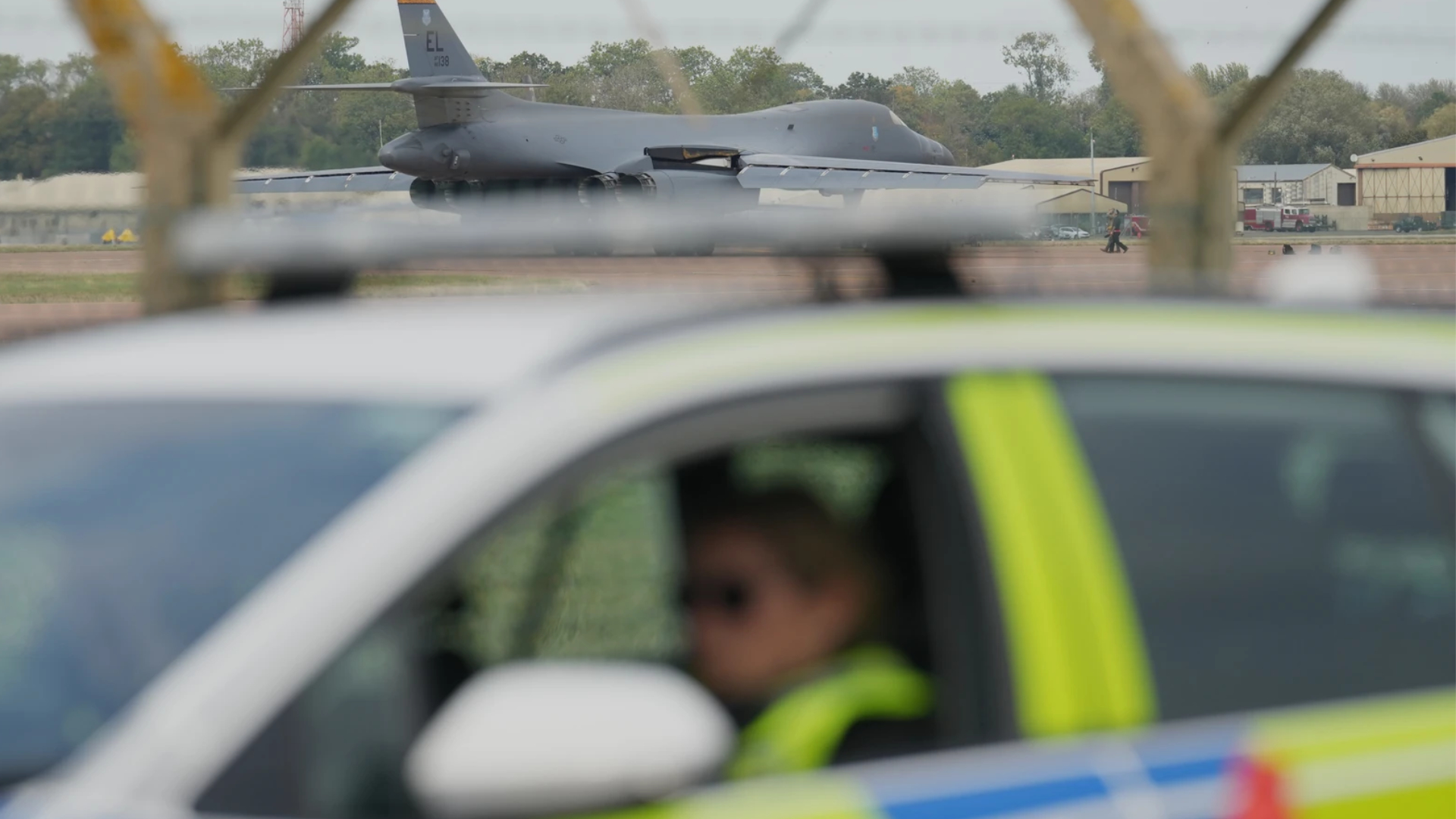 A B1 bomber prepares to take off as police officers man a checkpoint near RAF Fairford air base, in Fairford, England. (Photo: AFP)