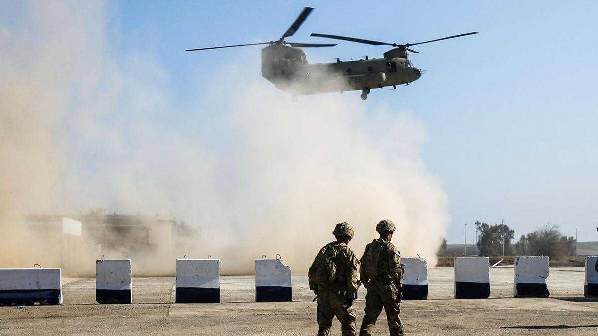 A helicopter lands at a military base in Iraq that houses troops fro the US-led Coalition against ISIS. (Photo: AFP)