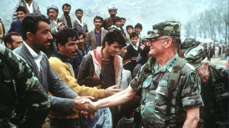 Operation Provide Comfort. Lieutenant General John M. Shalikashvili, Commander, Joint Task Force, greets Kurdish citizens at Iskiveren, June 6, 1991. (Photo: National Museum of the U.S. Navy)