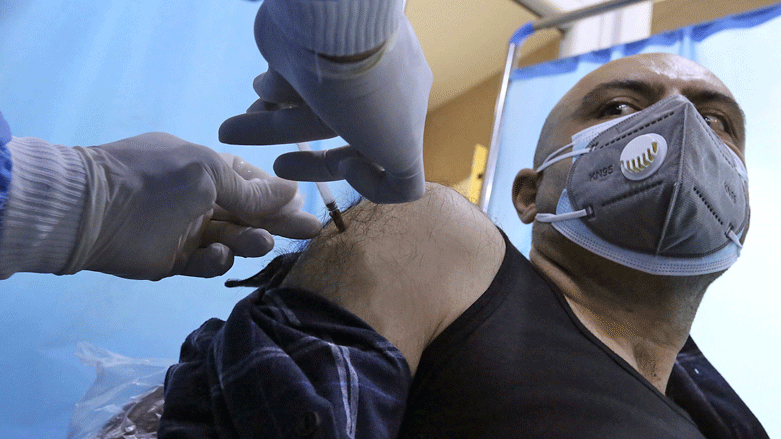 An Iraqi man is vaccinated against Covid-19 with the Chinese Sinopharm vaccine at a private nursing home in Baghdad, March 2, 2021. (Photo: Sabah Arar / AFP)