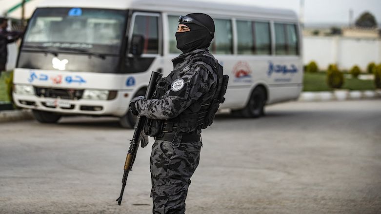 A member of Syrian Kurdish security forces looks on during the handover of orphaned children, whose parents were suspected of belonging to ISIS, to a Russian delegation in Qamishli on April 18, 2021.  (Photo: Delil  Souleiman / AFP)