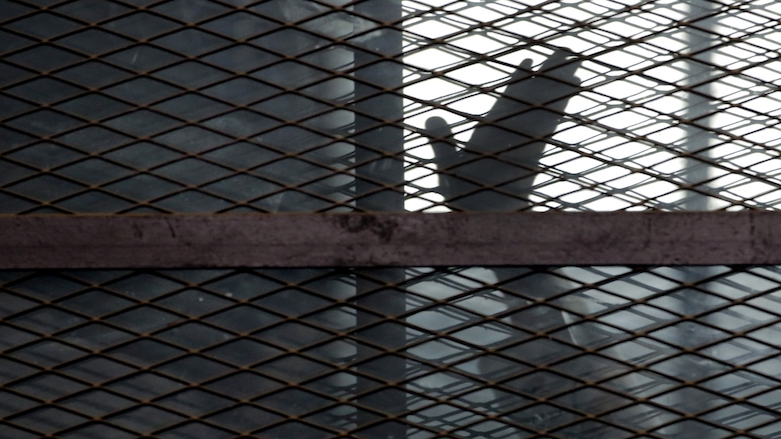 A Muslim Brotherhood brother waves from a cage in a courtroom in Torah prison, Egypt in August 2015. An April 2021 Amnesty International report said Iran, Egypt, Iraq and Saudi Arabia topped the global executions list. (Photo: Amr Nabil/AP)