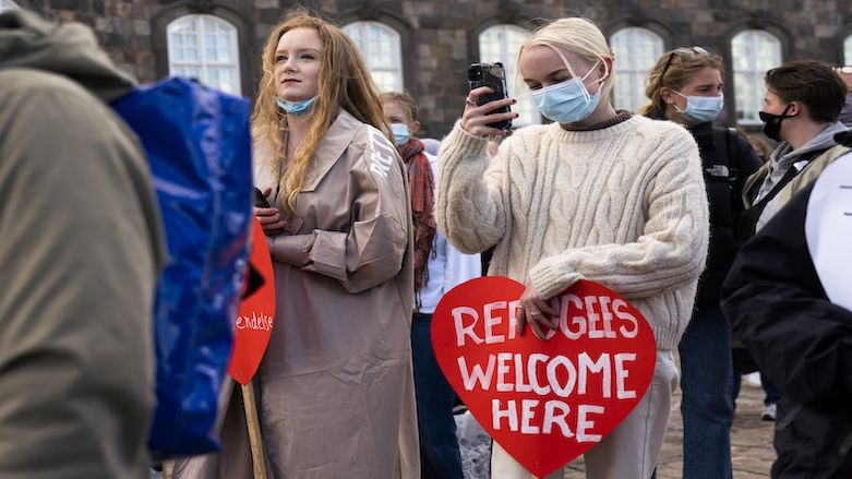 People attend a demonstration in Copenhagen against the tightening of Denmark's migration policy and deportation orders for Syrian refugees, April 21, 2021. (Photo: David Keyton/AP)