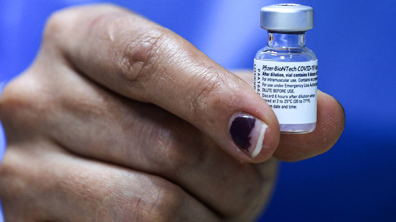 A nurse holds a used vial of Pfizer-BioNTech COVID-19 coronavirus vaccine at a vaccination center in the Kindi Hospital in Iraq's capital Baghdad, April 14, 2021. (Photo: Ahmad al-Rubaye / AFP)