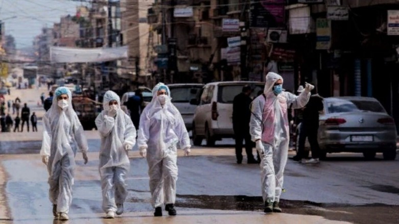 Medical workers oversee the disinfection of streets in order to halt the spread of the coronavirus in the northern Syrian city of Qamishli. (Photo: AP/Baderkhan Ahmad)