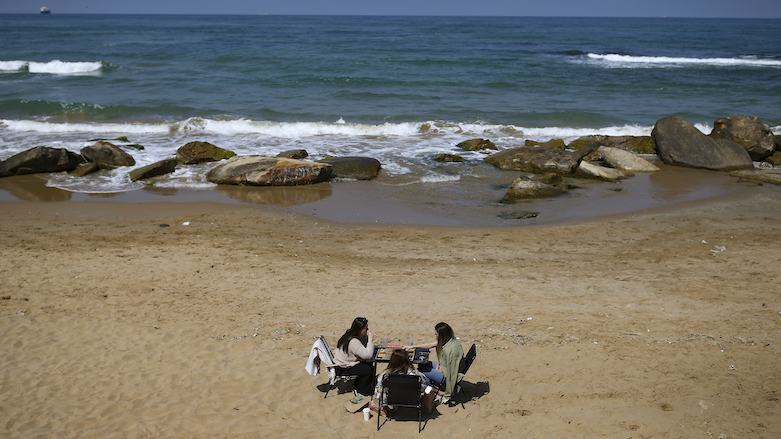 People sit on the beach in Kilyos, northern Istanbul, Thursday, April 29, 2021, a few hours before the start of the latest lockdown to help protect from the spread of the coronavirus in Turkey. (Photo: Emrah Gurel / AP)