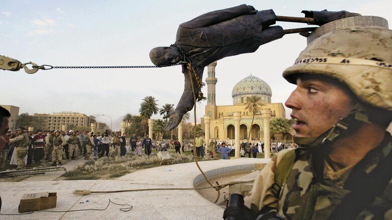 A US Army soldier witnesses the toppling of ex-Iraqi dictator Saddam Hussein's statue in Baghdad's Firdos Square, Apr. 9, 2003. (Photo: Jerome Delay/AP)