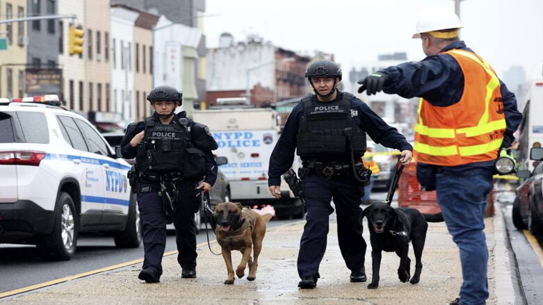 Officers with bomb-sniffing dogs look over the area after a shooting on a subway train, Apr. 12, 2022, in the Brooklyn borough of New York. (Photo: Kevin Hagen/AP)