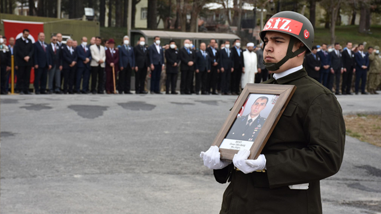 Portrait of dead Turkish soldier Omer Dilbash held by a Turkish soldier during his funeral procession in Hakkari province, April 19, 2022. (Photo: Hikmet Temesh/Anadolu Agency)