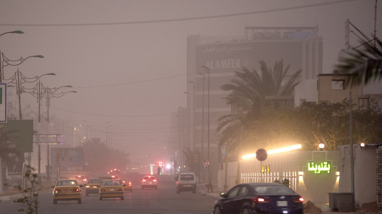 Vehicles drive down a road in Baghdad as thick dust blankets the city, March 31, 2023. (Photo: Murtadha Ridha/AFP)