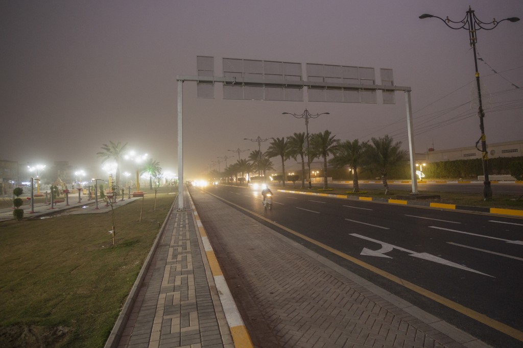 Vehicles drive down a road in Baghdad as thick dust blankets the city, March 31, 2023. (Photo: Murtadha Ridha/AFP)