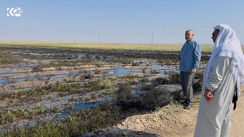 Two Arab farmers are pictured on their agricultural lands damaged by crude oil spills, April 5, 2023. (Photo: Dilan Barzan/Kurdistan 24)
