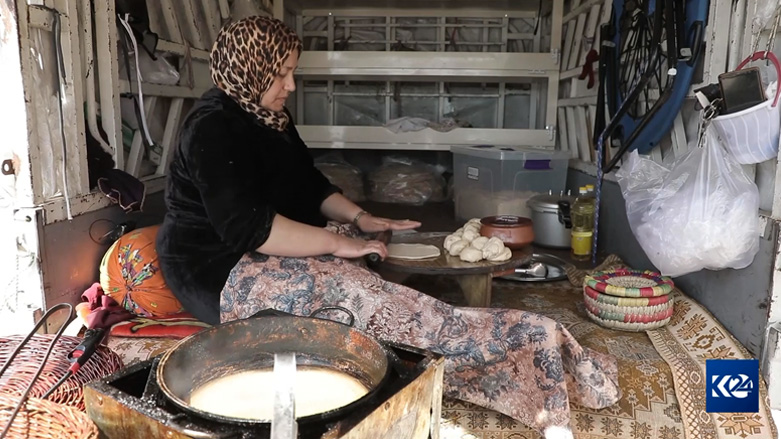 Shokhan Nasradin is bakin at the back of her KIA truck, which she had turned into a mobile kitchen, in Sulaimani, April 8, 2023. (Photo: Kurdistan 24)