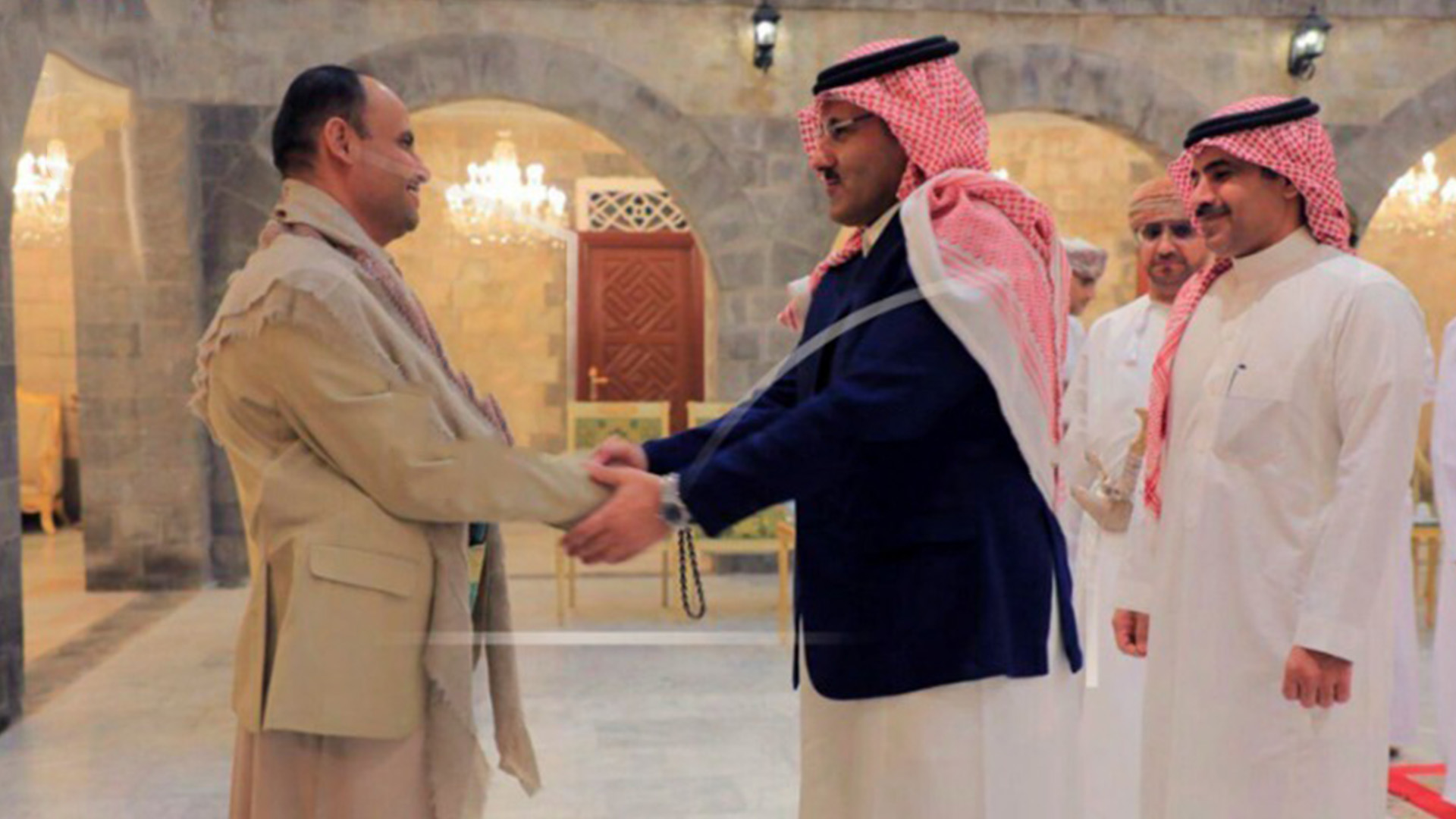 Ansar Allah, head of the Houthi’s supreme political council Mahdi al-Mashat, left, shakes hands with Saudi Arabia’s Ambassador to Yemen Mohammed bin Saeed Al-Jaber, in Sanaa, Yemen. (Photo: Ansar Allah Media Office)
