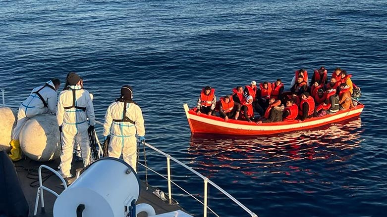 This handout photo released on April 10, 2023, by the Guardia Costiera press office, shows coast guards on a ship and migrants in a small boat during an ongoing rescue operation. (Photo: AFP)