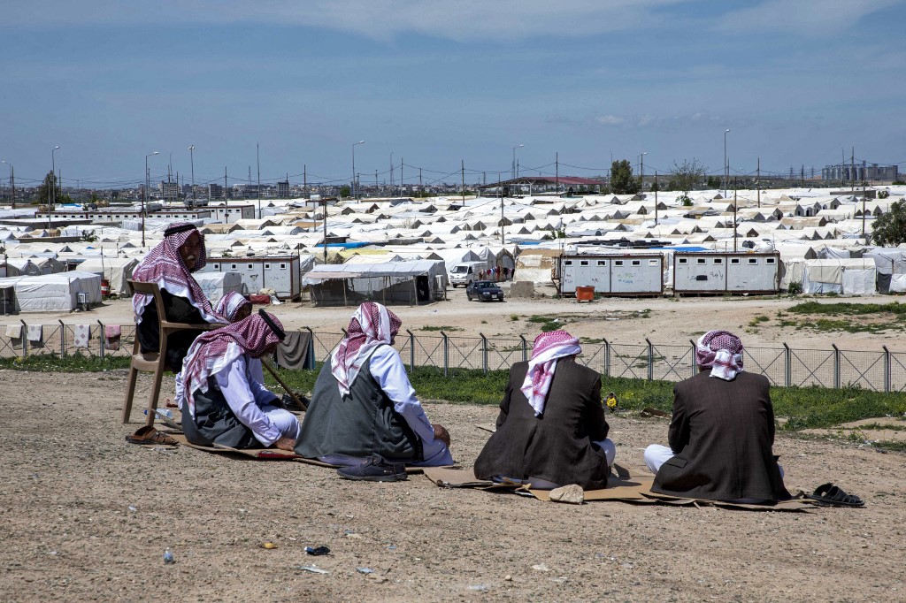 Displaced Iraqi men from the Yazidi community sit outside at the Sharya camp, some 15 kilometres near the northern Iraqi city of Dohuk, April 19, 2023. (Photo: Safin Hamed/AFP)