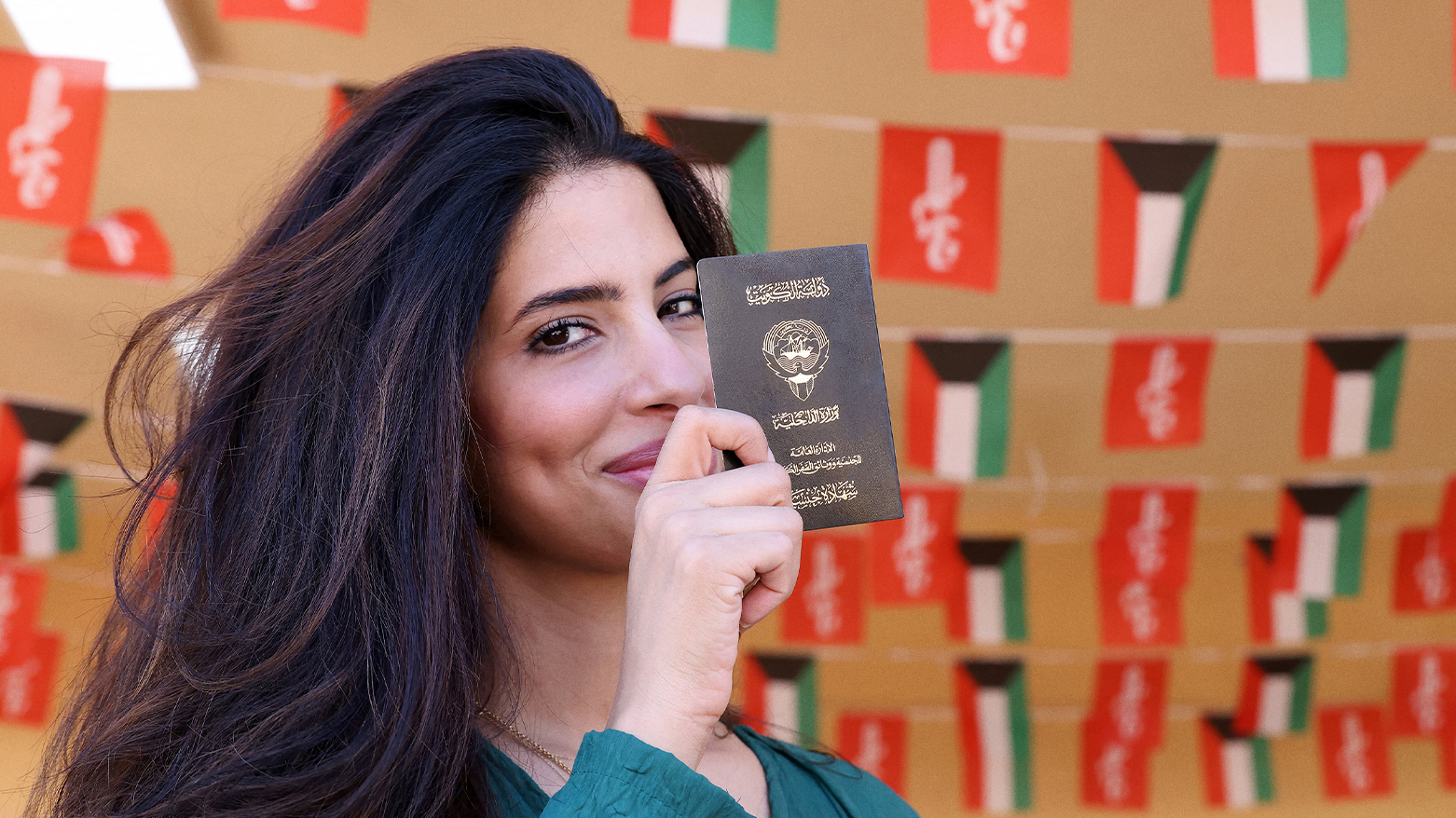 A Kuwaiti woman displays her passport as she arrives to vote in parliamentary elections at a polling station in Kuwait City. (Photo: YASSER AL-ZAYYAT / AFP)