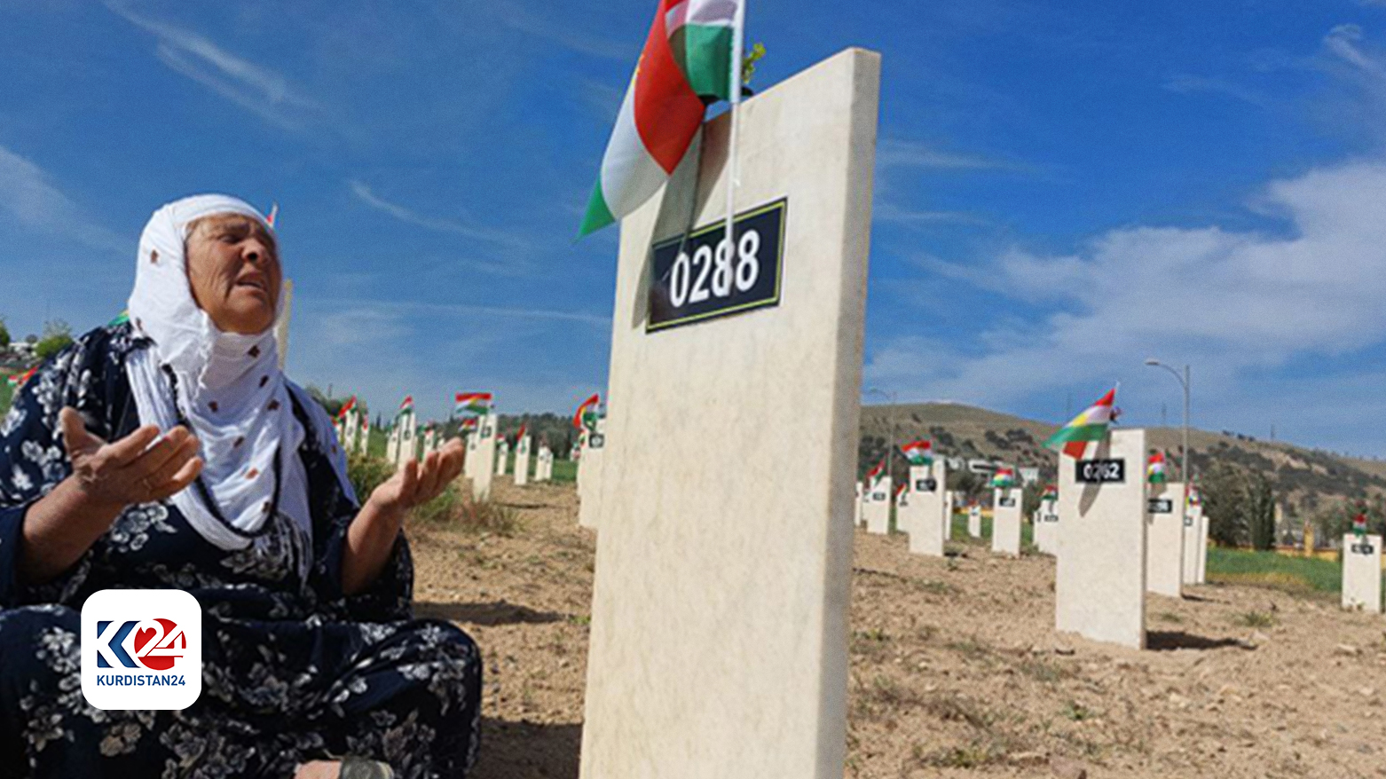 woman is praying at the gravesite of an Anfal victim in the Kurdistan Region's Chamchamal district, April 14, 2022. (Photo: Dana Hama Gharib/Kurdistan 24)
