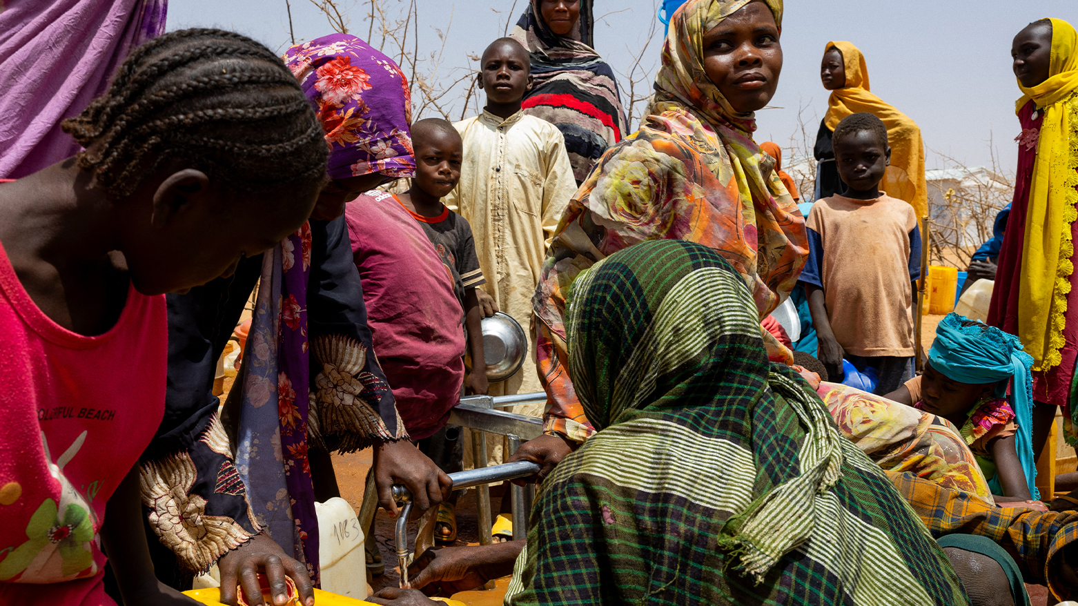 Sudanese refugees gather to fill cans with water from a water point in the Farchana refugee camp, on April 8, 2024. (Photo: AFP)