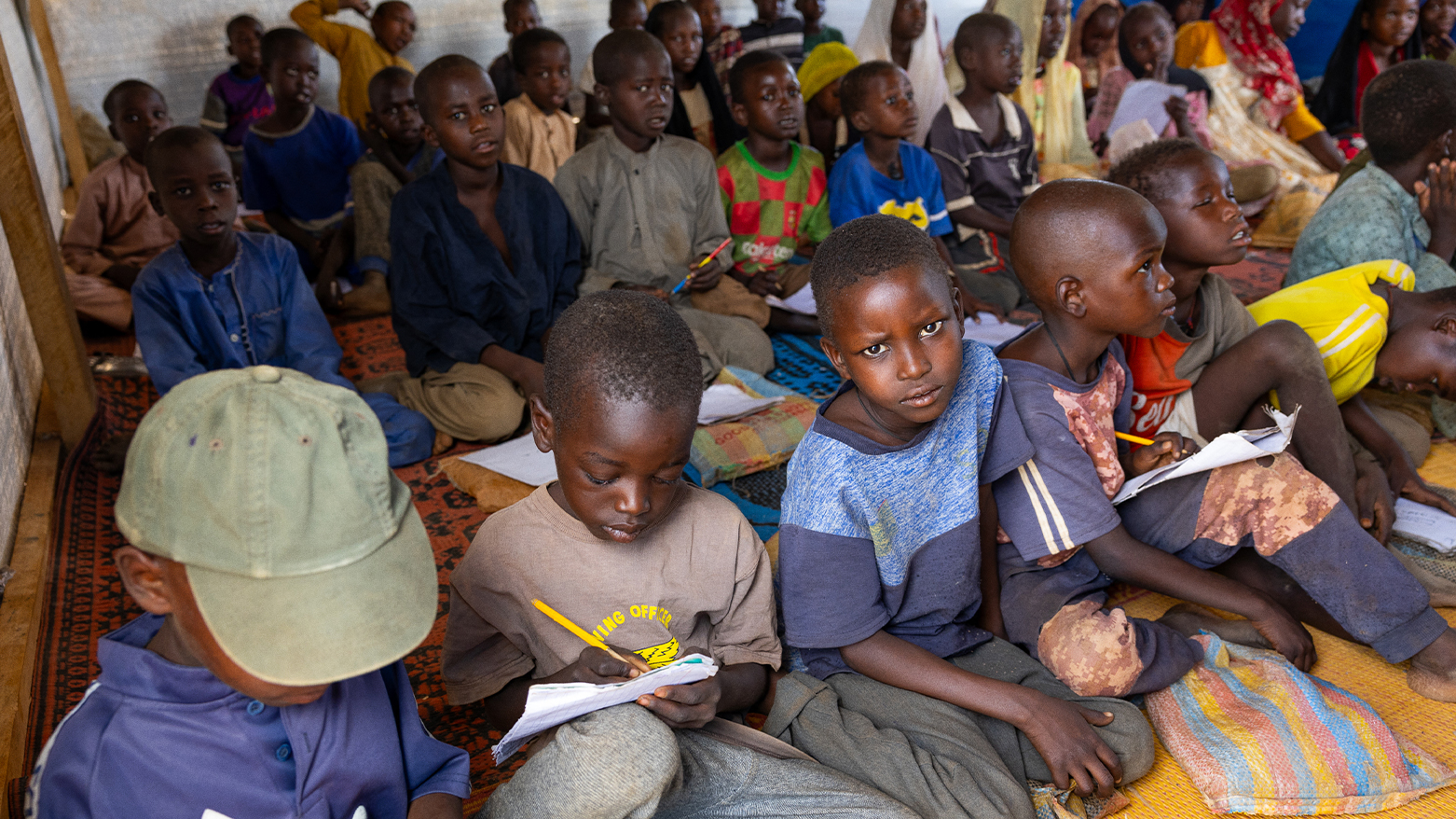 Young Sudanese refugees attend an Arabic lesson at the Al-Tadamoun school in the Farchana refugee camp, on April 8, 2024.  (Photo: AFP)