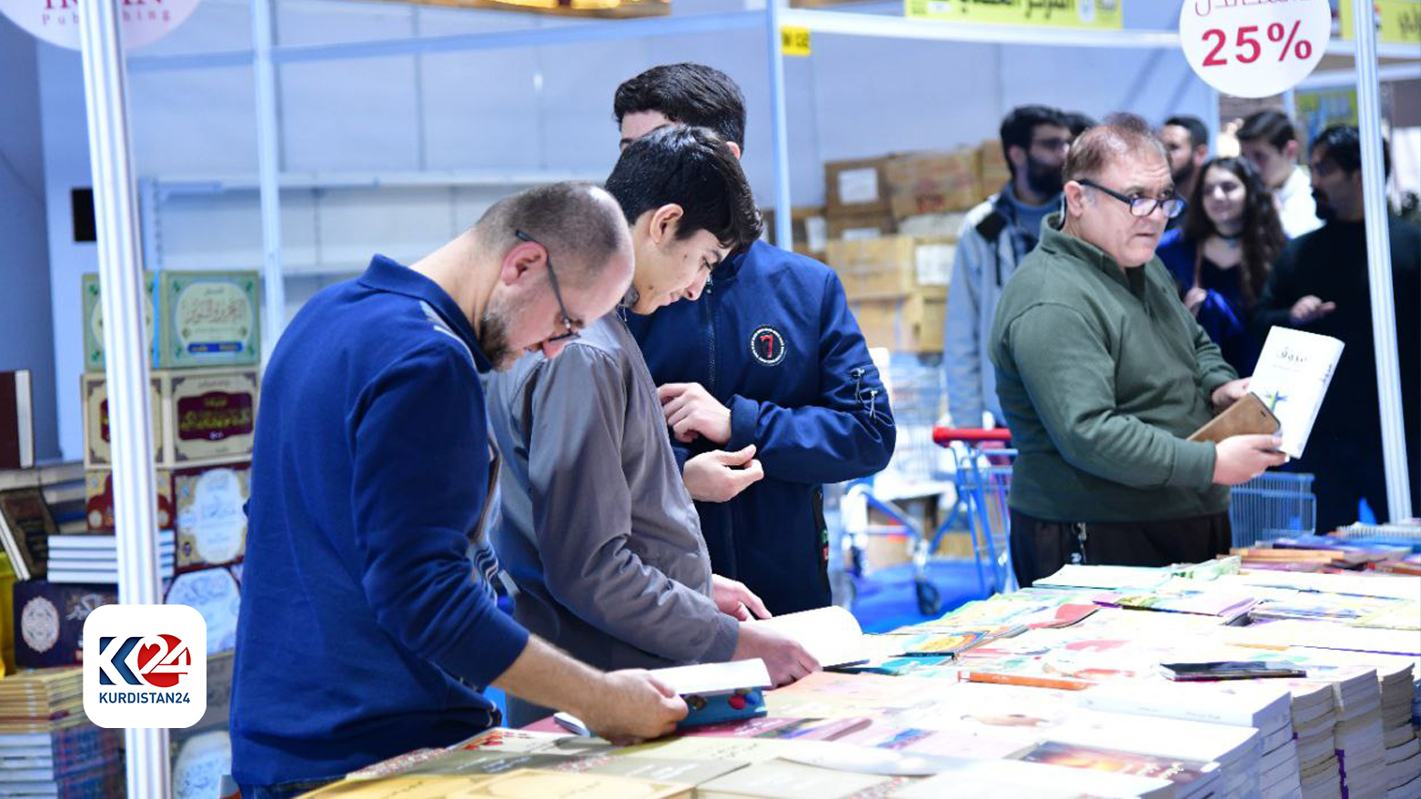 The photo shows book enthusiasts searching for their desired books. (Photo: Kurdistan 24)
