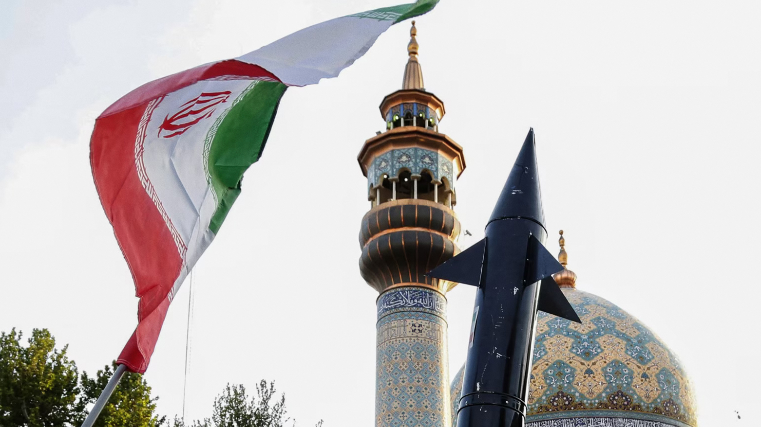 Iranians lift up a flag and the mock-up of a missile during a celebration following Iran's missiles and drones attack on Israel, on April 15 2024, at Palestine square in central Tehran. (Photo: VOA)