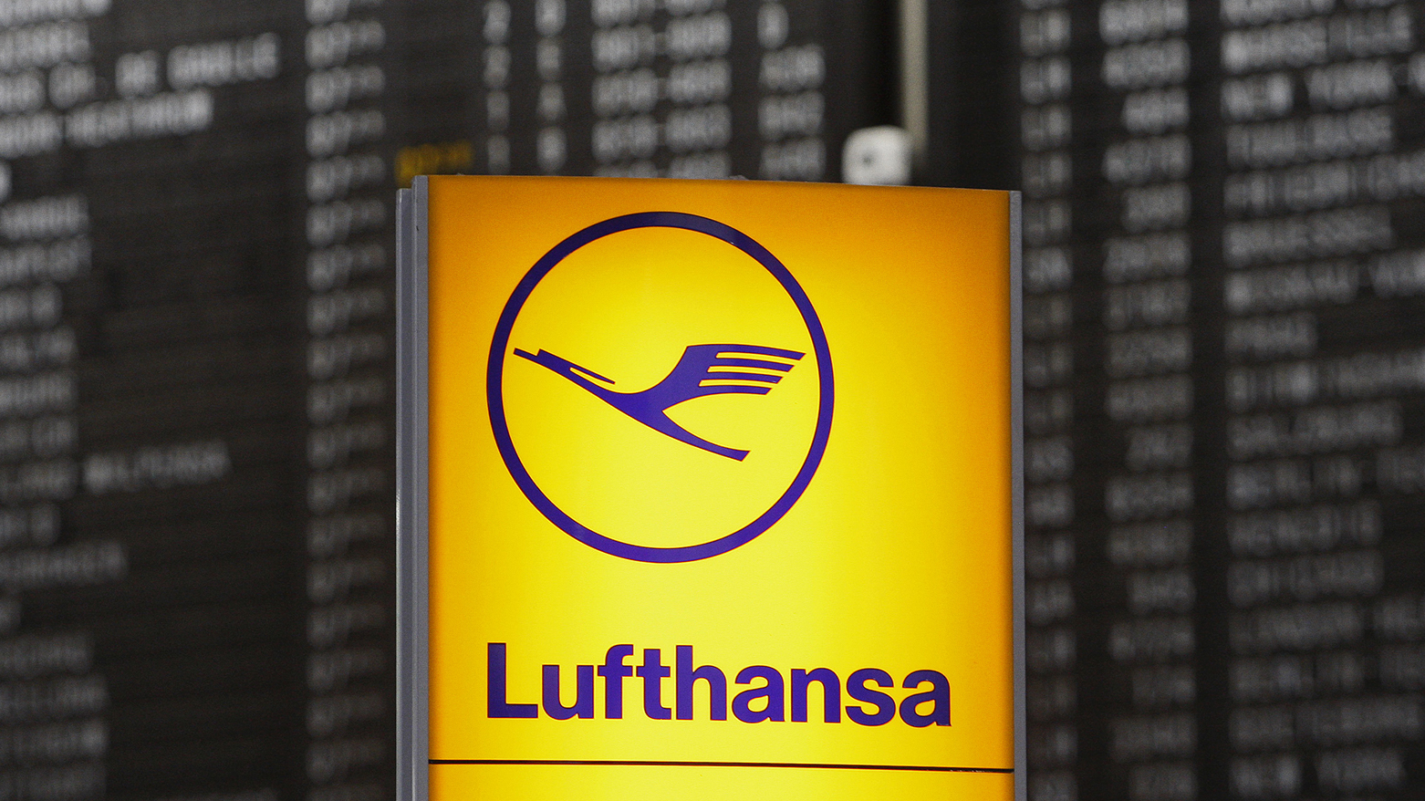 The logo of German airline Lufthansa is seen in front of a display panel at the airport in Frankfurt, central Germany, on Friday, Aug. 1, 2008. (Photo: AP/Daniel Roland)