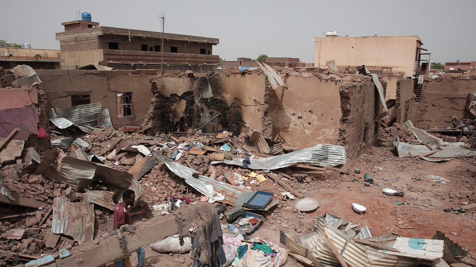 A man walks by a house hit in recent fighting in Khartoum, Sudan, Tuesday, April 25, 2023. (Photo: AP/Marwan Ali, File)