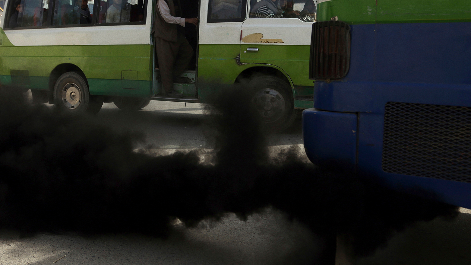 Smoke comes out from the exhaust pipe of an old mini-bus. (Photo: AP)