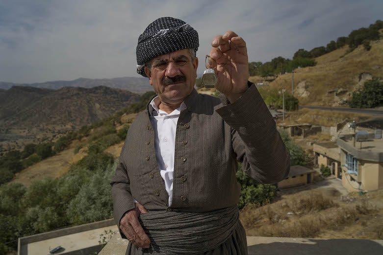 Hama Saeed Abdulqader with his brother’s watch shortly after it was discovered by a MAG deminer in 2018. (Photo: Sean Sutton/MAG)