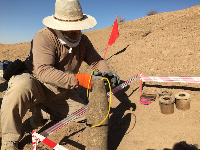 A MAG team member prepares explosives to be destroyed, Laylan, July 6, 2021. (Photo: Joanne Stocker-Kelly)
