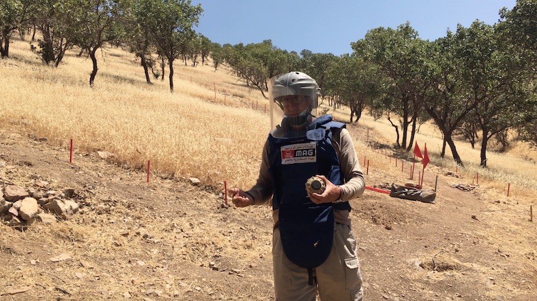 Chalak Taha holds up a VS-50 anti-personnel blast mine he has just defused, Wilyawa, July 5, 2021. (Photo: Joanne Stocker-Kelly)