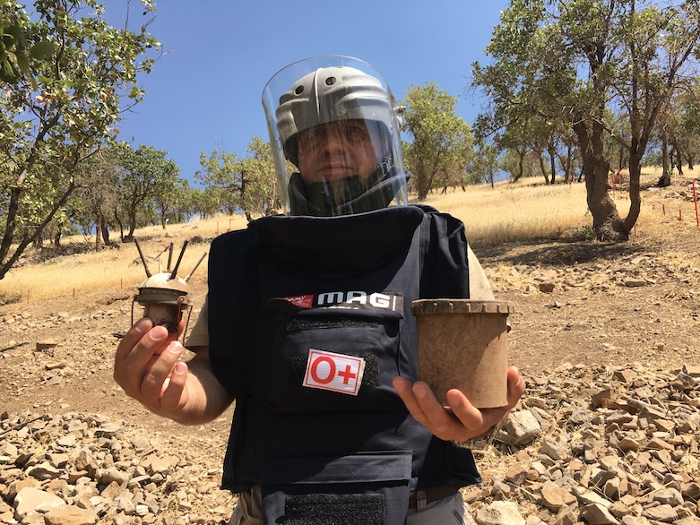 Jabbar Fatih Mahmoud, a MAG national technical field manager, with a Valmara 69 mine recovered outside Wilyawa village, July 5, 2021. (Photo: Joanne Stocker-Kelly)