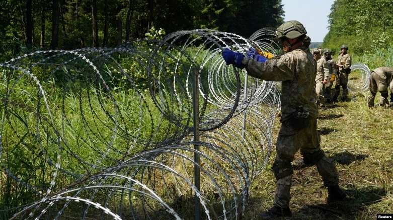 Lithuanian soldiers install razor wire on the border with Belarus on July 9. (Photo: Reuters)