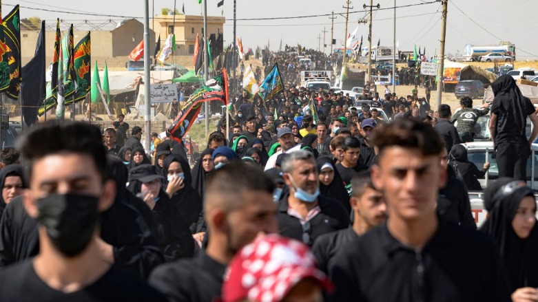 Iraqi pilgrims walk toward the shrine of Imam Zayn al-Abidin in the northern city of Mosul, on the tenth day of the month of Muharram which marks the peak of Ashura, on August 19, 2021. (Photo: Zaid AL-Obeidi / AFP)